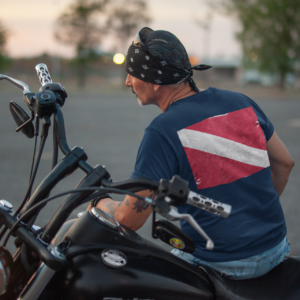 Back view tee mockup of a middle aged biker watching the sunset 20218a